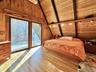 Primary bedroom with glass doors out to...