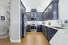Kitchen has custom cabinetry, quartz countertops.