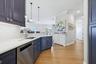 Kitchen has custom cabinetry, quartz countertops.