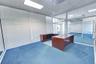 Glass-partitioned office with views across the interior.