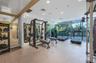 Fitness facility featuring floor-to-ceiling windows, full-wall mirrors, recessed lighting, and synthetic flooring
