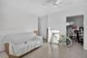 Interior space featuring speckled terrazzo flooring, white walls, and a ceiling-mounted fan with integrated lighting