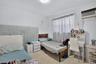 Room featuring neutral walls, speckled composition flooring, and a wall-mounted air conditioning unit