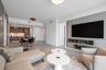 Open-concept interior featuring large-format tile flooring, recessed ceiling lighting, and a custom built-in media console