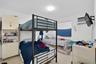Room featuring terrazzo flooring, white walls, and a window with a fixed curtain rod