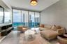 Floor-to-ceiling windows, built-in shelving, textured wall finish, tile flooring, and a glass-railing balcony
