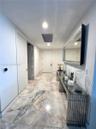 Foyer featuring large-format stone flooring, recessed lighting, and a solid-core door