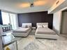 Large-format stone tile flooring, accent wall, and sliding glass balcony doors