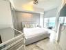 Floor-to-ceiling sliding glass doors, marble flooring, textured accent wall, and built-in mirrored wardrobe