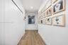 Hallway featuring wood-finish flooring, recessed lighting, and floor-to-ceiling closet doors