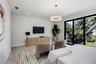 Large-format tile flooring, drum-style chandelier with metallic accents, built-in light-tone wood-finish cabinetry, and floor-to-ceiling sliding glass