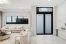 Double entry doors with frosted glass panels and an overhead transom window, large-format tile flooring, recessed lighting, and a built-in wall-mounte