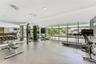 Fitness center featuring floor-to-ceiling windows, mirrored wall panels, recessed lighting, and resilient flooring