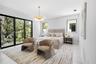 Large format sliding glass doors, polished stone flooring, drum pendant lighting, and oversized windows
