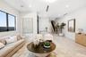Open-concept interior featuring large-format tile flooring, recessed lighting, and a staircase with a black metal railing