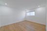 Interior space featuring wood-finish flooring, white walls, and recessed ceiling lighting