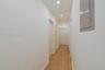 Hallway featuring wood-finish flooring, recessed lighting, and multiple interior doors with louvered closet detailing