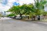 Property exterior featuring horizontal privacy fencing, mature trees, and a concrete driveway