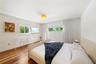 Room featuring wood-finish flooring, recessed lighting, and dual windows