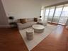Floor-to-ceiling windows featuring sliding glass doors and wood-finish flooring