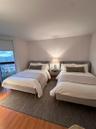 Wood-finish flooring, floor-to-ceiling window, and neutral wall tones