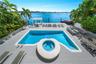 Waterfront deck featuring a swimming pool with a circular spa, a detached covered pavilion, and a private dock