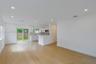 Open interior featuring wood-finish flooring, recessed lighting, white cabinetry, a peninsula counter, and sliding glass doors