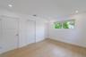 Bright interior featuring wood-finish flooring, recessed lighting, and a single-pane horizontal window