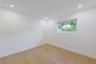 Neutral interior featuring wood-finish flooring, recessed lighting, and a horizontal sliding window