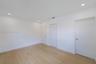 Neutral-toned space featuring wood-finish flooring, recessed lighting, and multiple interior doors with brushed nickel hardware