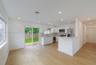 Kitchen featuring white flat-panel cabinetry, light-toned stone countertops, stainless steel appliances, recessed lighting, and wood-finish flooring