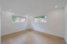 Bright interior room featuring wood-finish flooring, recessed lighting, and dual slider windows