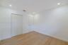 Neutral interior featuring wood-finish flooring, recessed lighting, and white cabinetry doors