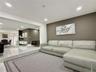Polished tile flooring, recessed ceiling lighting, and contrasting accent walls