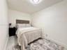 Room featuring neutral-toned walls, light-colored tile flooring, and a flush-mount ceiling light fixture