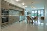 Contemporary kitchen featuring wood-finish cabinetry, stainless steel built-in oven and microwave, mosaic tile backsplash, and polished stone-finish f