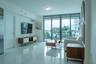Polished stone flooring, expansive floor-to-ceiling glass sliding doors, and a private balcony