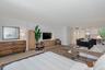 Open-concept interior featuring wood-finish flooring, neutral walls, and recessed lighting