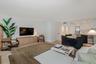 Open-concept floor plan featuring light-toned wood-finish flooring, recessed lighting, and kitchen cabinetry with integrated stainless steel appliance
