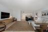 Open-concept interior featuring light wood-finish flooring, recessed lighting, and crisp neutral wall color