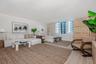 Neutral interior with wood-finish flooring and expansive windows