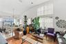 Vaulted ceilings, expansive multi-pane windows, elevated tile platform, and wood-finish flooring