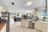 Kitchen featuring flat-panel cabinetry, tiled countertops, stainless steel dishwasher, double-basin sink, and tile flooring