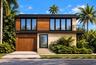 Modern two-story architectural exterior featuring natural stone cladding, wood-finish paneling, an integrated garage, and an upper-level balcony with 