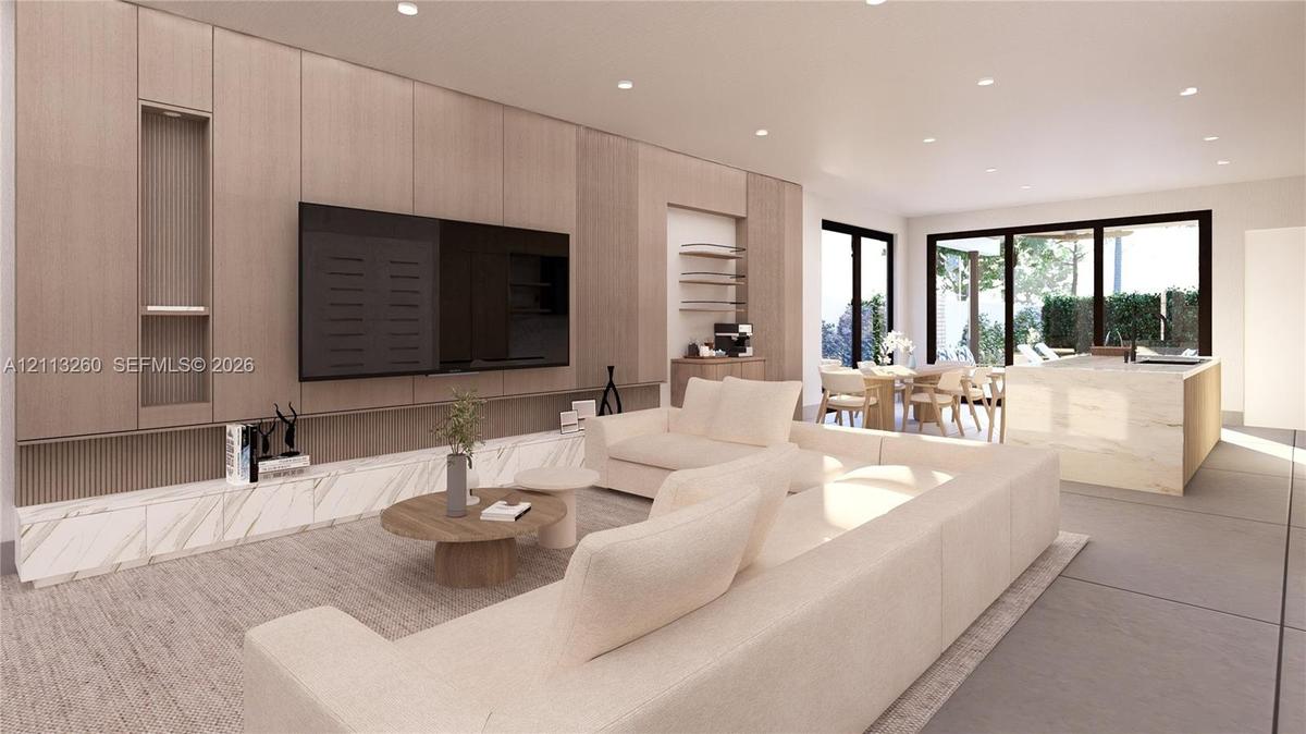 Full-height wood-panel cabinetry with integrated shelving, stone-finish low-profile built-in media console, recessed ceiling lighting, and large-forma