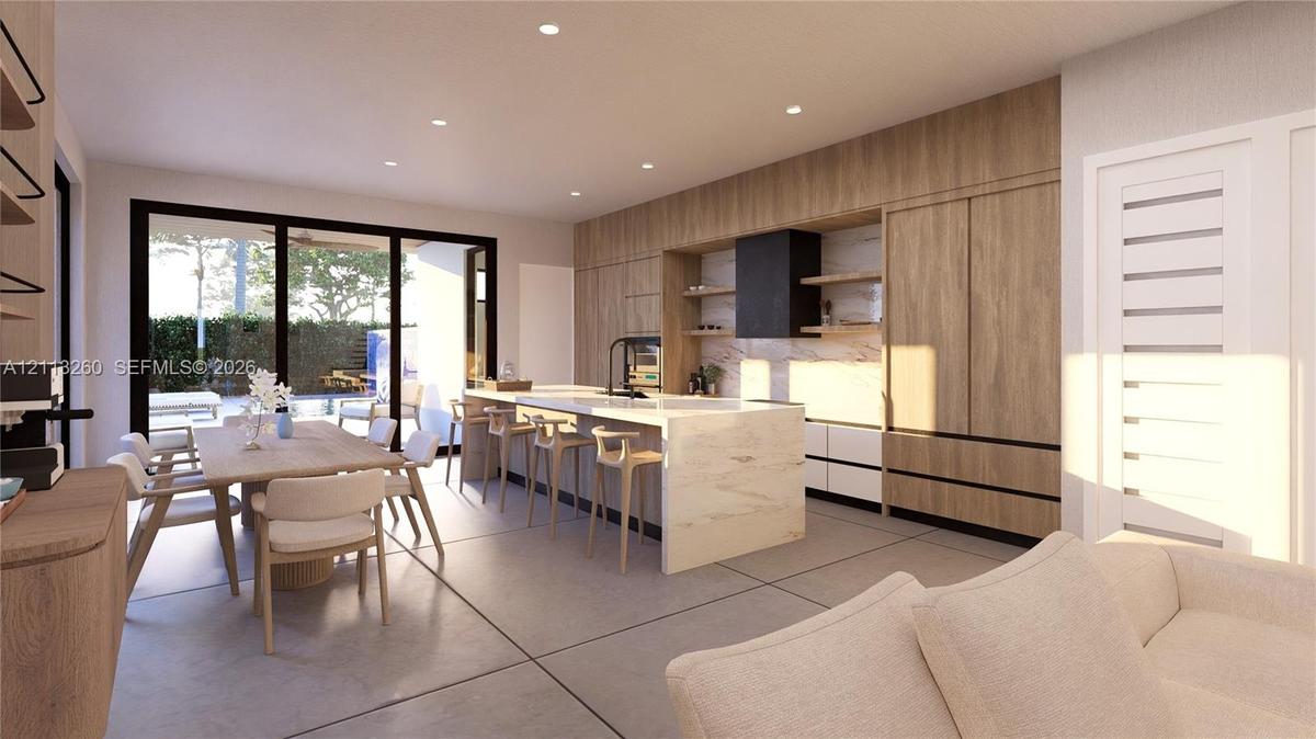 Modern kitchen featuring floor-to-ceiling wood-finish cabinetry, a waterfall-edge stone island, built-in black vent hood, light-toned stone backsplash