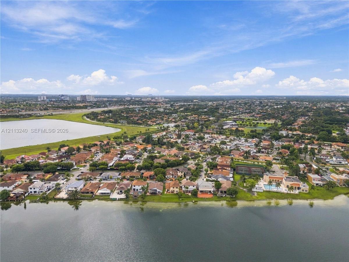 Aerial perspective of waterfront property featuring direct shoreline access and expansive lake exposure