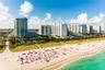 Coastal high-rise buildings featuring glass balconies and direct beach access