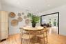Wood-finish flooring, recessed lighting, and a prominent doorway featuring high-contrast black trim