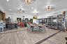 Open-concept area featuring wood-finish flooring, recessed lighting, multiple ceiling fans, and two wall-mounted ductless climate control units